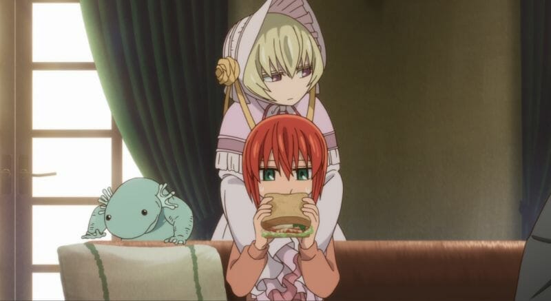 A blonde woman wearing a dress and bonnet hugs a red-haired woman who is eating a sandwich.
