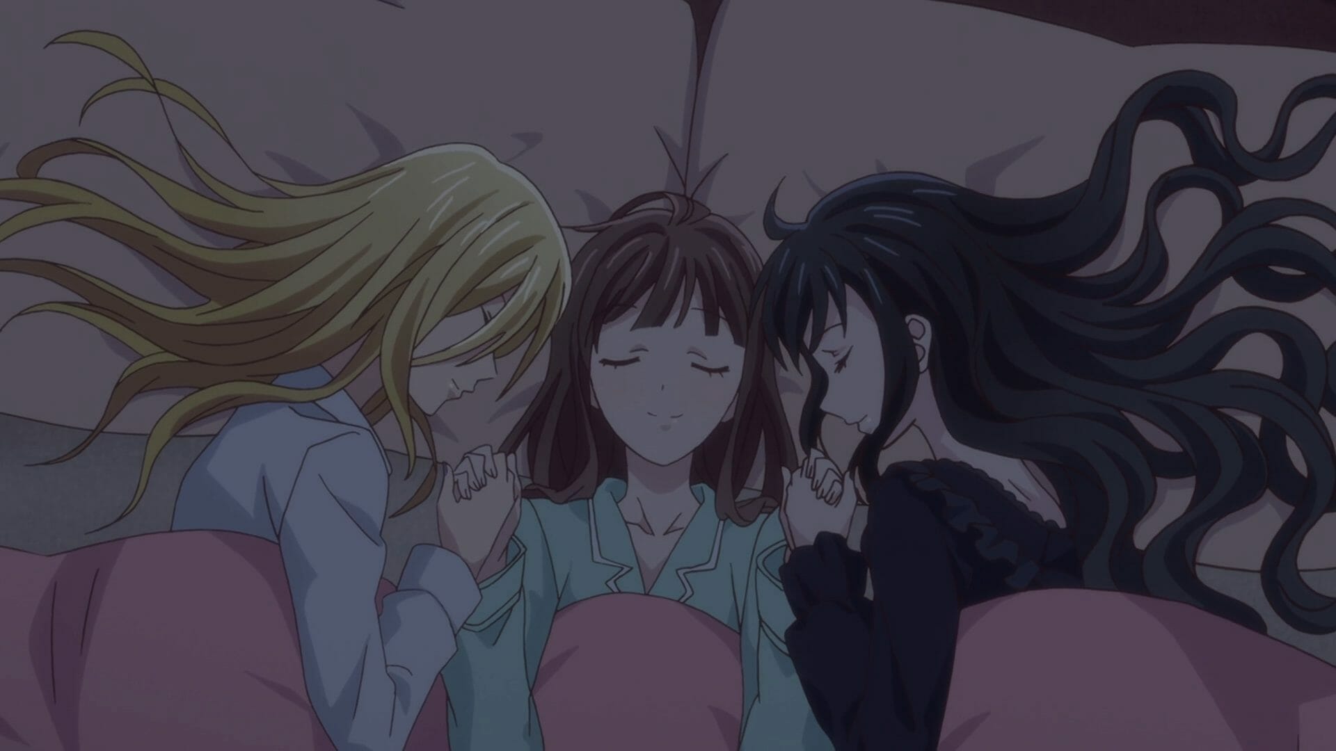 Fruits Basket (2019) Anime Still - Arisa Uotani and Saki Hanajima embrace Tohru Honda warmly as they sleep together in the same bed.