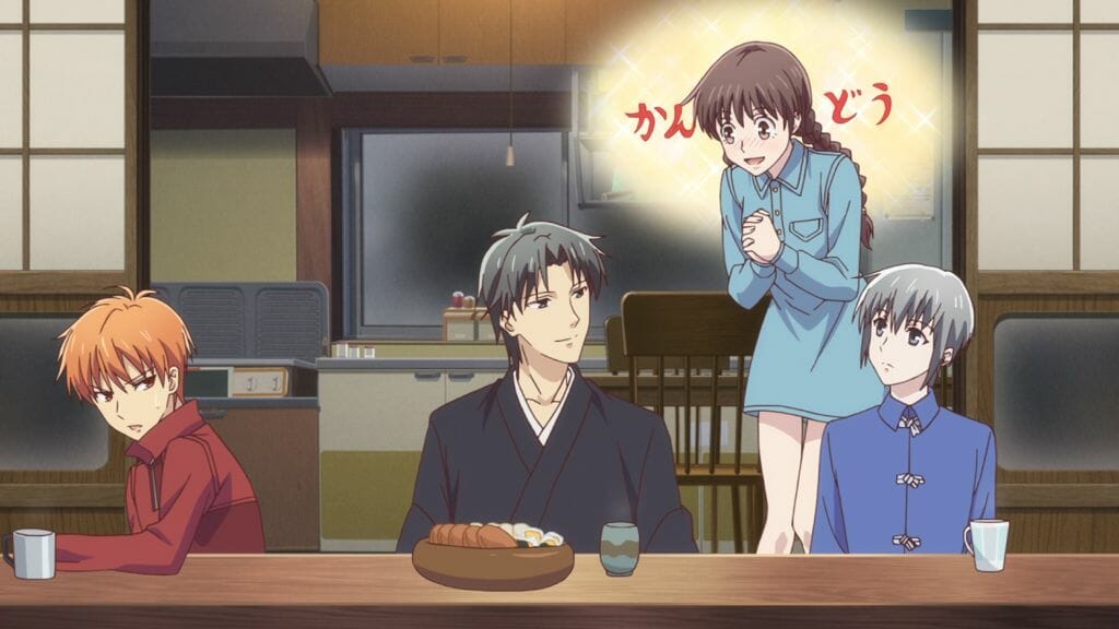 Fruits Basket (2019) Anime Still - Tohru Honda gushes at Shigure Soma, who smiles smugly. Yuki Soma and Kyo Soma both sit, unimpressed