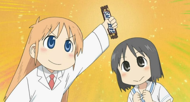 Nichijou still - Hakase holds up a Snickers bar as Nano stares in awe.