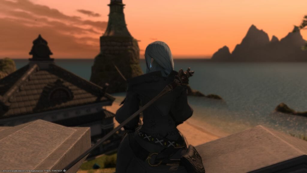 Skye Graneterre, a Duskwight Elezen, gazes at the sea from the back yard of the Gillionway Trading Company's Free Company home in Final Fantasy XIV