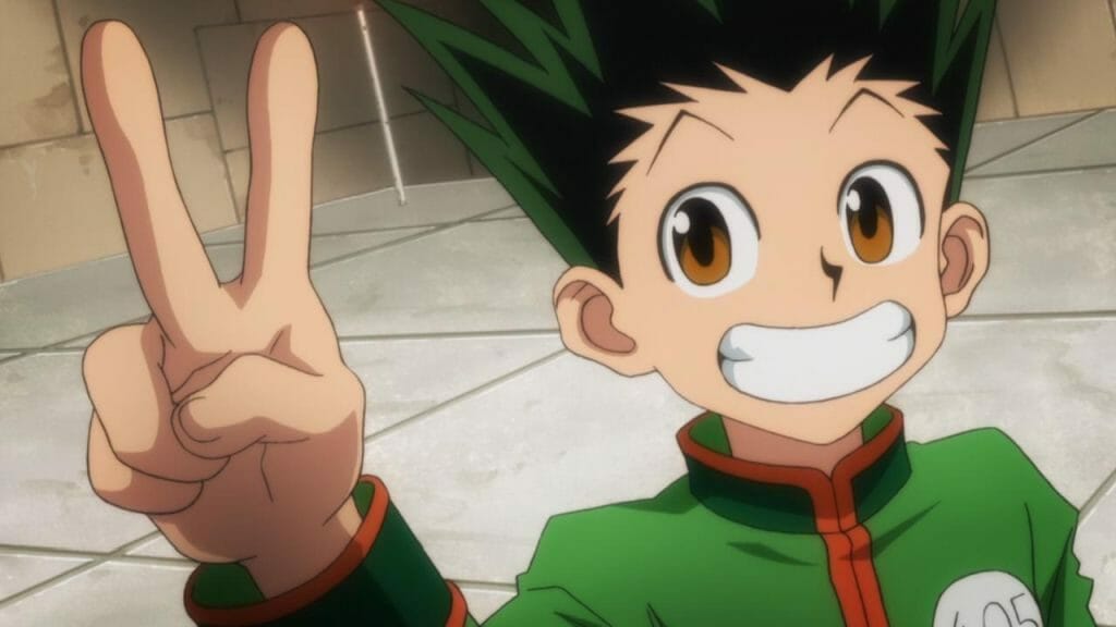 Screenshot from Hunter x Hunter that depicts Gon smiling as he gives a peace sign.