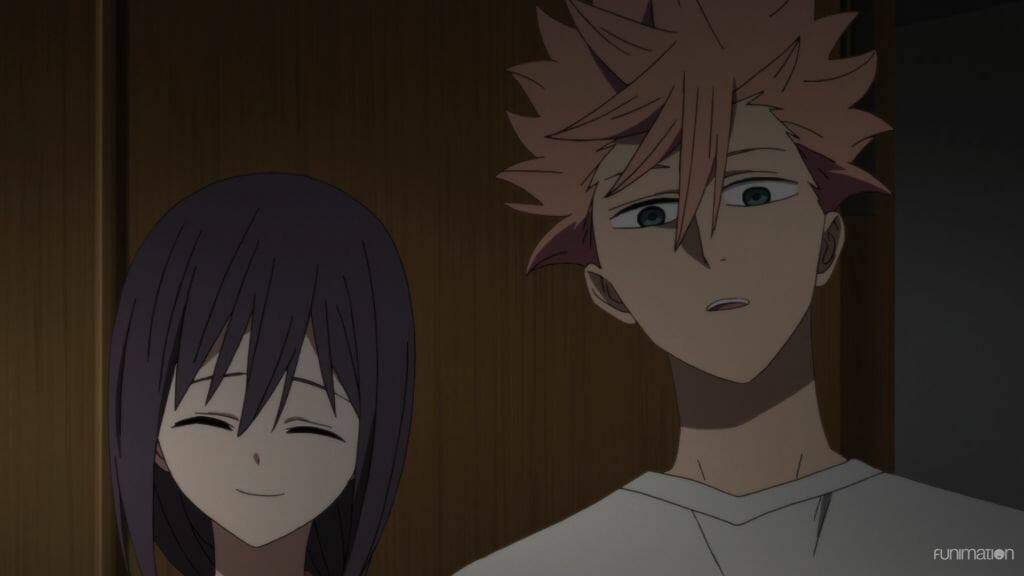 Id Invaded Episode 9 Still - a man with pink hair looks at the camera in confusion. A woman with dark hair smiles behind him.