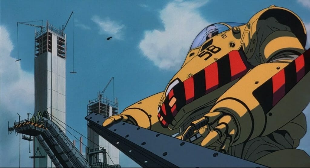 Patlabor Movie Still - A yellow robot holds a girder under a blue sky.