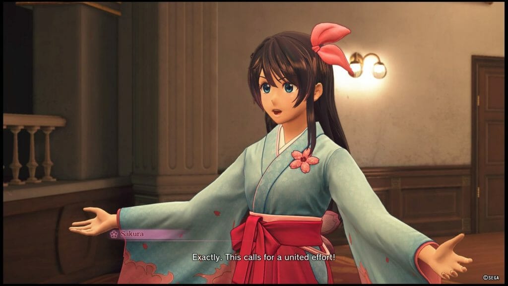 Sakura Wars 2019 game still - A brown-haired woman in a blue kimono stands with open arms. Dialogue: "Exactly. This calls for a united effort!"