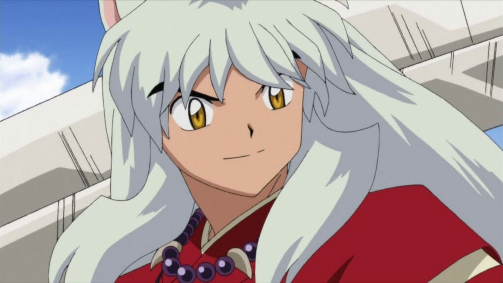 InuYasha anime still - a white-haired man with dog ears, wearing a red kimono.