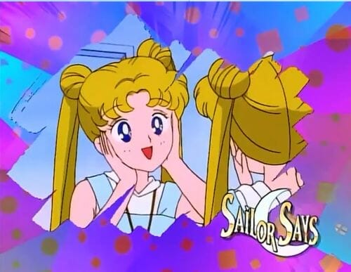 Sailor Moon Anime Still - a blonde girl smiles at herself in the mirror.