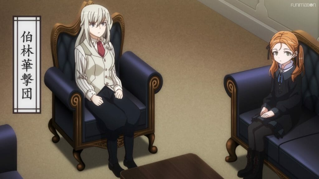 A blonde woman and a red-haired girl wearing casual clothes sit in leather chairs.