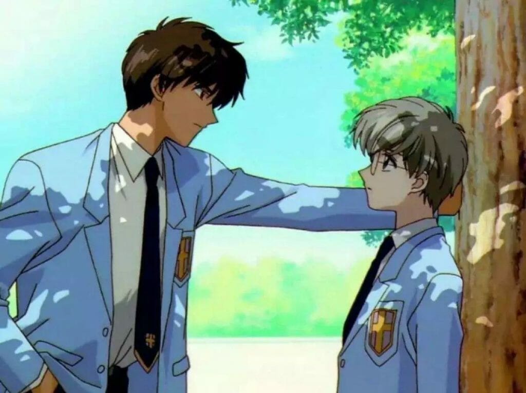 A brown-haired teenage boy does a kabedon to a smaller blonde teenage boy.