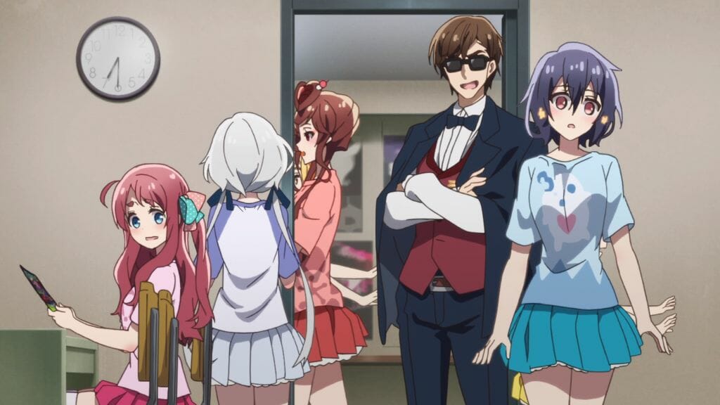 Several women staring blankly in all directions as they wander in a room. A man in glasses smiles as he watches.