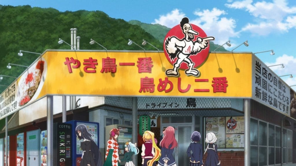 Six women stand in front of a storefront with a yellow sign, emblazoned with a red bubble that has a drawing of a smiling chicken inside it.