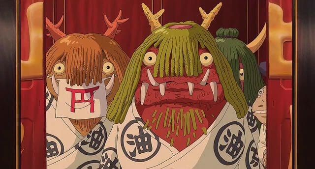 Still from Spirited Away which depicts frumpy monsters with green hair, horns, sharp teeth, and beady eyes