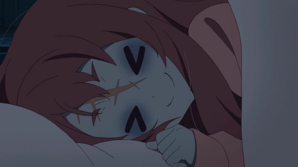 Still from Zombie Land Saga Episode 10, which shows a red-haired zombie woman grinning eagerly as she lays down.