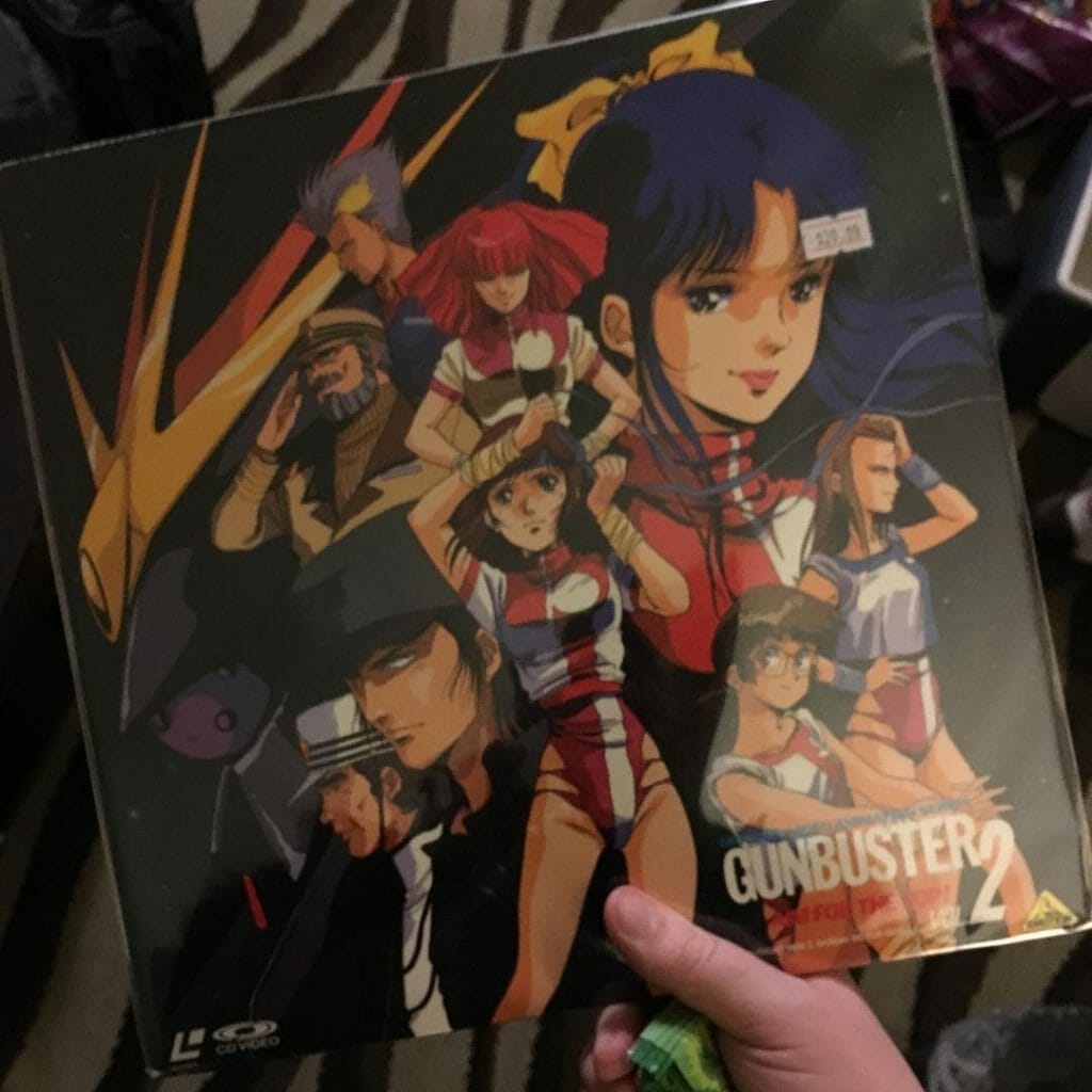 Photo of a hand holding the laserdisc for Gunbuster 2