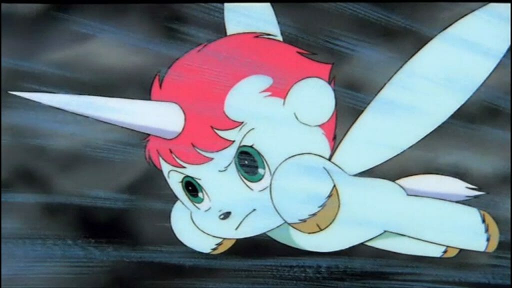 Still from The Fantastic Adventures of Unico that features unico, a blue unicorn, flying forth with a look of determination upon his face.