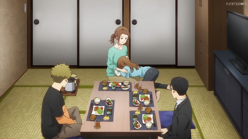 Ikebukuro West Gate Park Episode 5 that depicts a woman comforting a younger woman, as two men look on. All four are seated at a table at dinnertime.