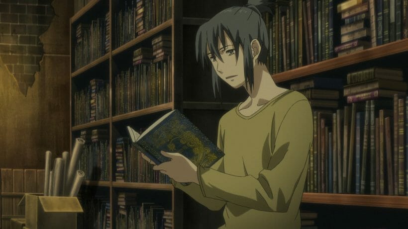 Still from No. 6, depicting a dark-haired man as he casually flips through a book.