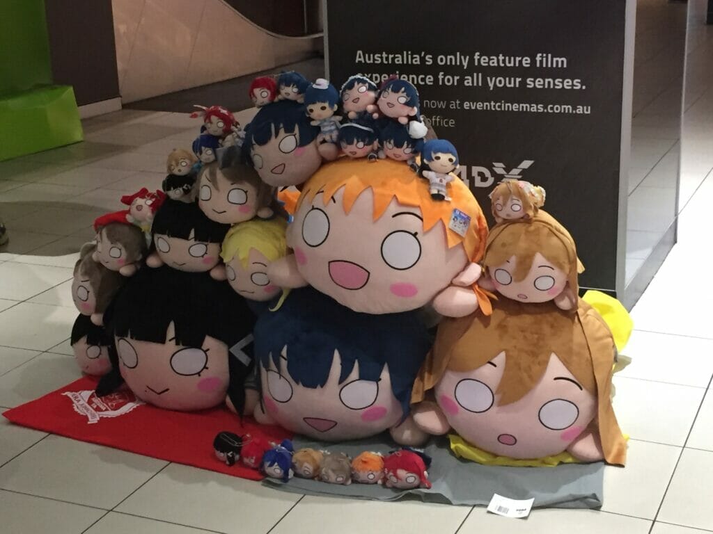 A pile of oversized Nesoberi, or "bean" plushes depicting the Love Live cast