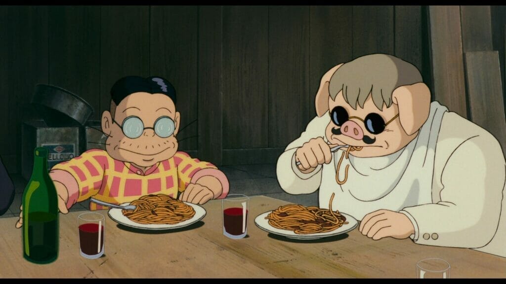 Still from Porco Rosso that depicts a pig-headed man eating pasta next to a short man wearing thick glasses.