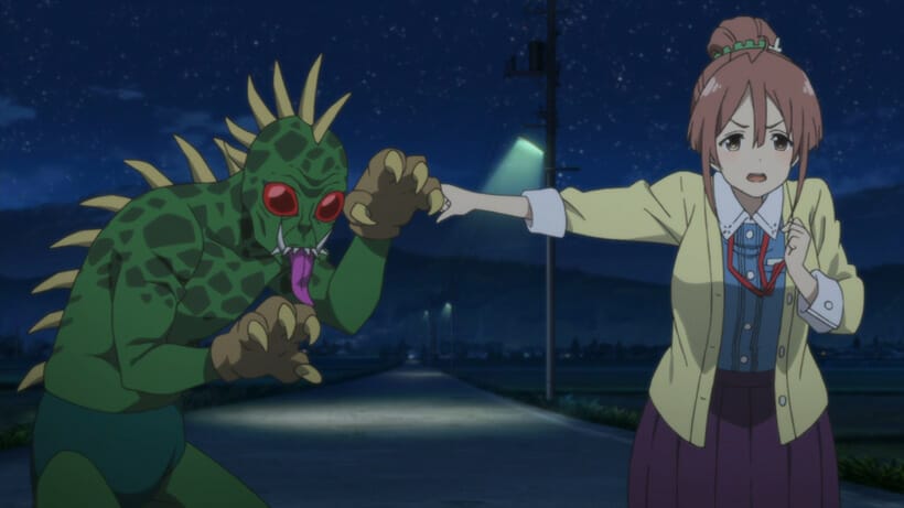 Still from Sakura Quest - A brown-haired woman with a ponytail points incredulously at a man in a green monster costume.