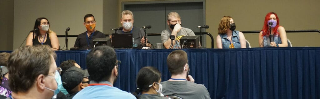 Photo from Discotek Media's panel, featuring Justin Sevakis, Brady Hartel, and Mike Toole, flanked by Amber Lee Connors and two other members of the Sound Cadence dub studio team.