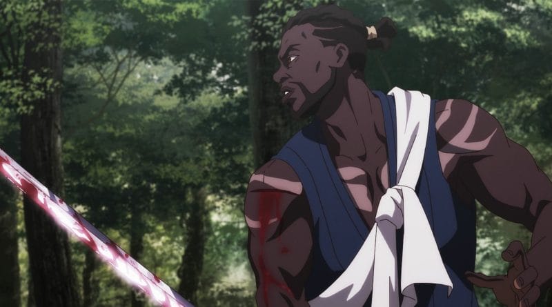 Black samurai Yasuke wields a bloodstained blade as he stands at the ready in a lush forest.