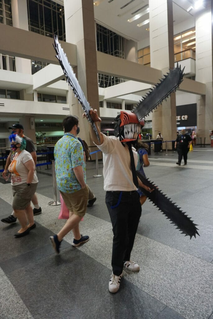 Photo from Otakon 2021 - A man dressed as the lead character of Chainsaw Man poses for the camera