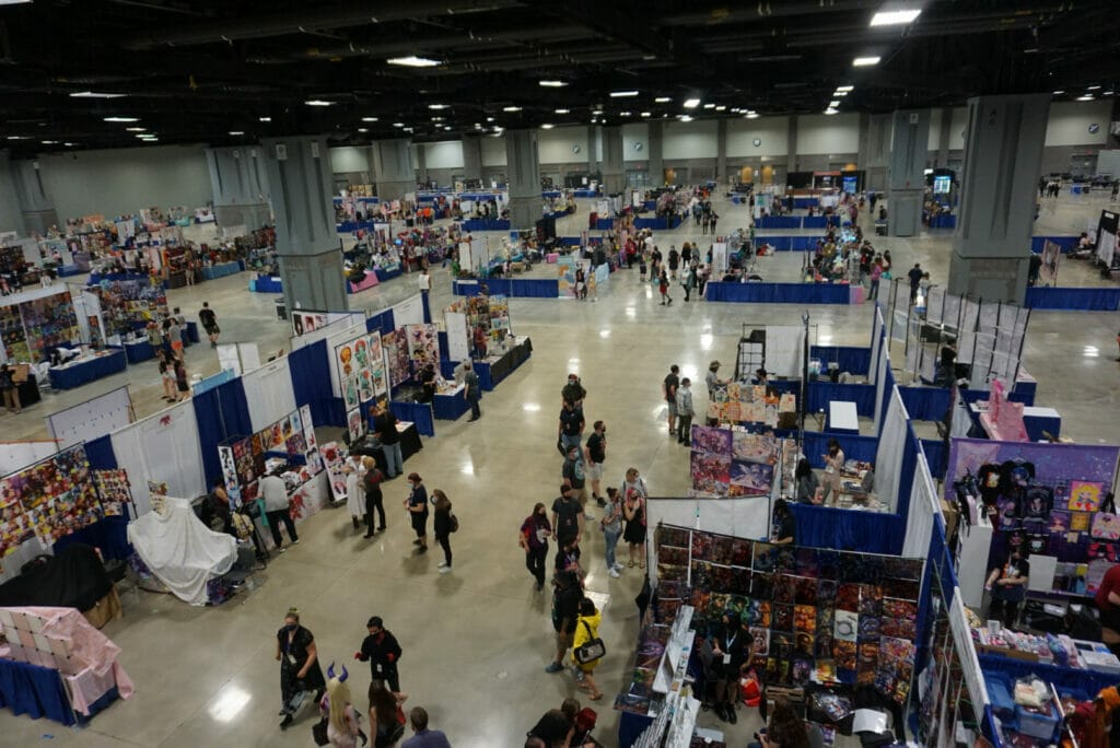 Overhead photo of individuals milling about the Artist's Alley at Otakon 2021.