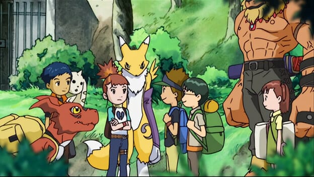 A group shot of the Digimon Tamers main cast and their monster companions, set against a forest backdrop