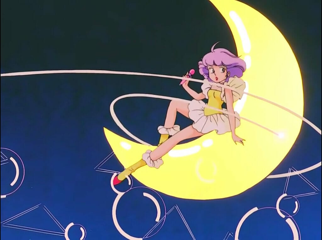 Title card from Creamy Mami, showing a purple-haired idol lounging on a crescent moon prop