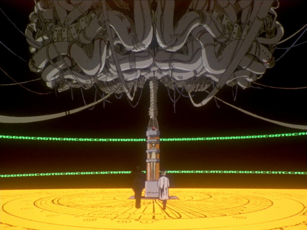 A man and a woman stand in front of a giant mechanical brain.