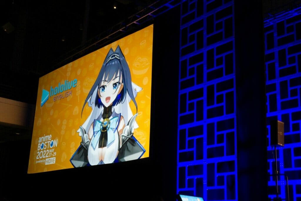 Photo from Anime Boston 2022's opening ceremonies. Ouro Kronii appears in a pre-recorded message from Hololive English.