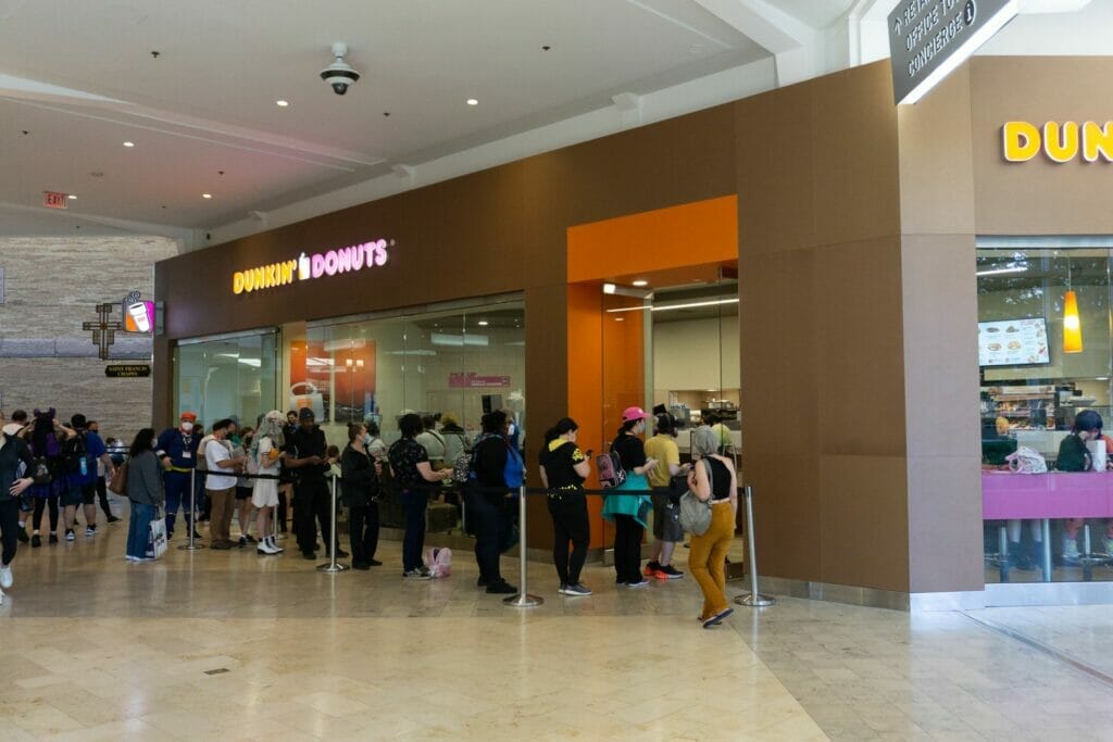 Photo of a line of people outside of a Dunkin Donuts