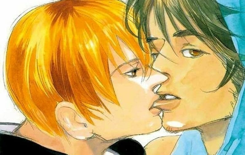 A red-haired man and a brown-haired man engage in a passionate kiss; the brown-haired man's eyes dart toward the camera.