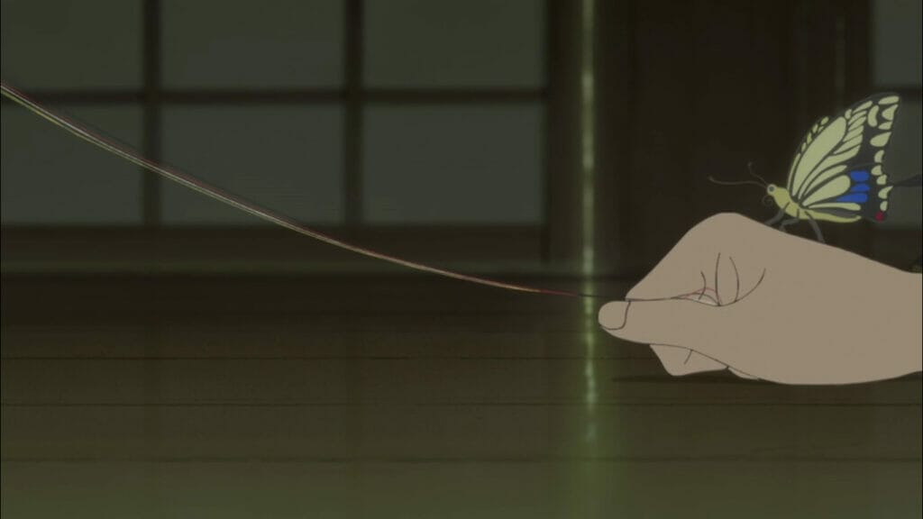 Closeup of Tokuko's hand grasping a prayer thread