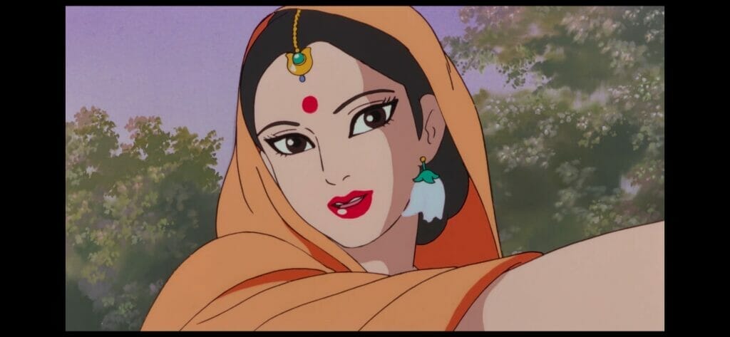 Stil lfrom the Ramayana anime, which depicts a woman in an orange headscarf, who smiles as she looks at the camera.