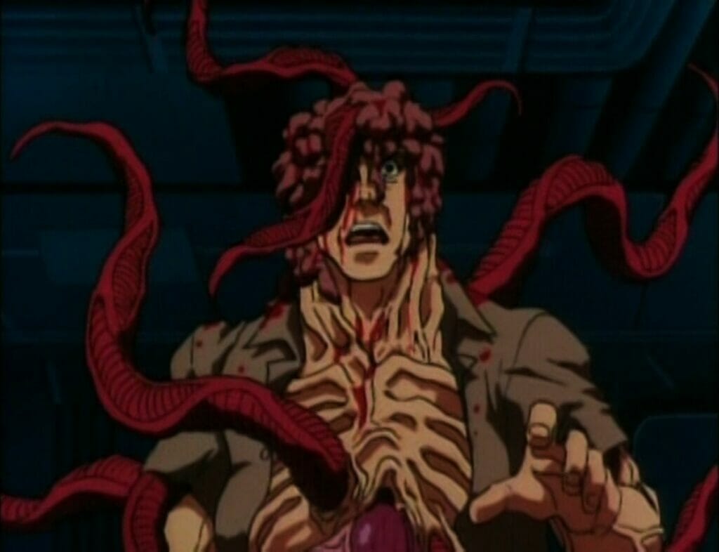 Still from Genocyber that depicts a man whose body is morphing into a grotesque creature; his brain is exposed and red tendrils snake from his body.