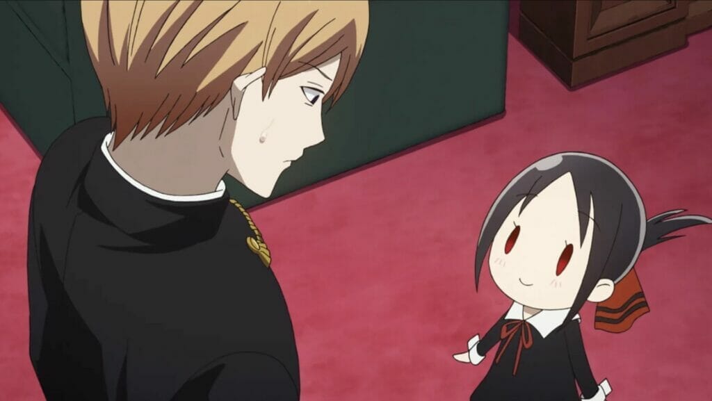 Still from Kaguya Sama: Love is War-The First Kiss That Never Ends. A blonde man looks down at a young brunette girl who smiles at him expectantly.