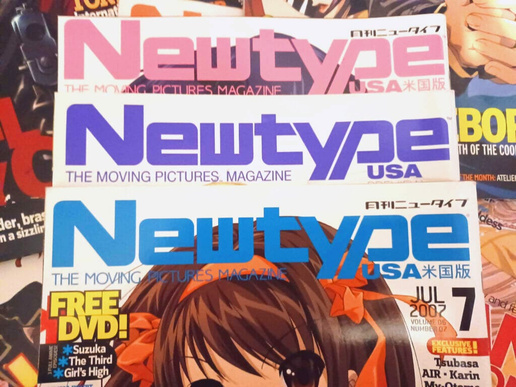Three issues of Newtype USA stacked together, with Haruhi's face poking out the top