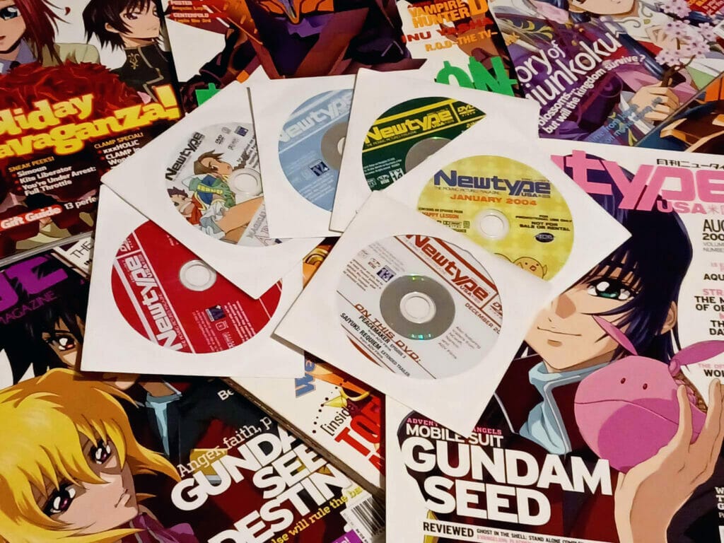 A scattered pile of the promotional DVDs that often came with Newtype issues