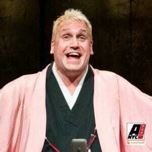 Photo of Katsura Sunshine - a white man with blonde hair wearing a pink and green kimono.