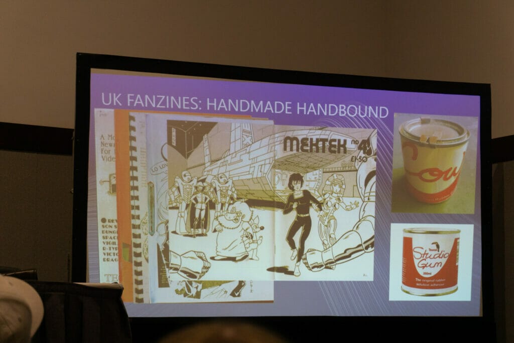 Photo of a PowerPoint slide depicting scans of the MekTek no. 4 fanzine, as well as tins of Studio Gum and Cow Gum Text: UK Fanzines: Handmade Handbound