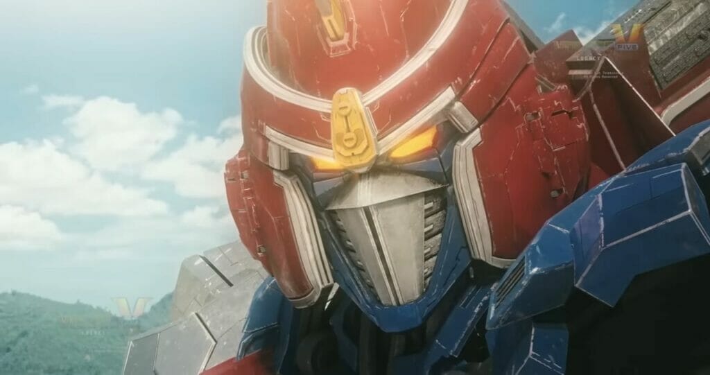 Photo of Voltes V, a red, yellow, blue, and silver robot as it stands against a blue sky
