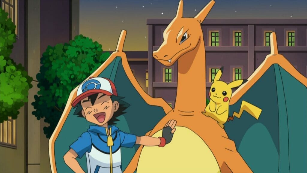 Ash Ketchum - a boy with shaggy black hair and a red baseball cap, smiles happily as he rests his hand on the tummy of a Charizard - a giant orange dragon.