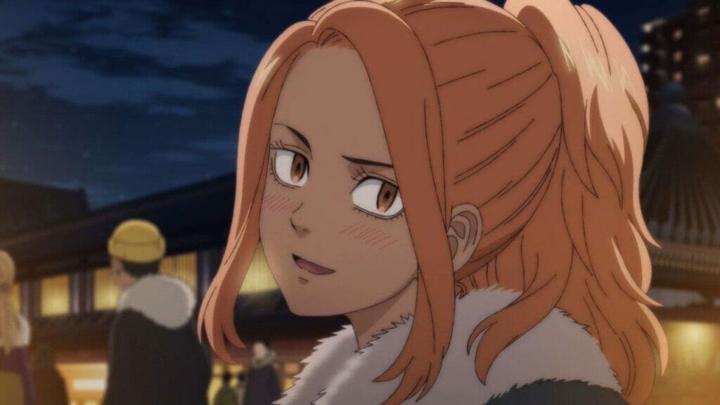 Yuzuha Shiba from Tokyo Revengers: Christmas Showdown, a woman with long orange hair, smirks as she looks toward the camera.