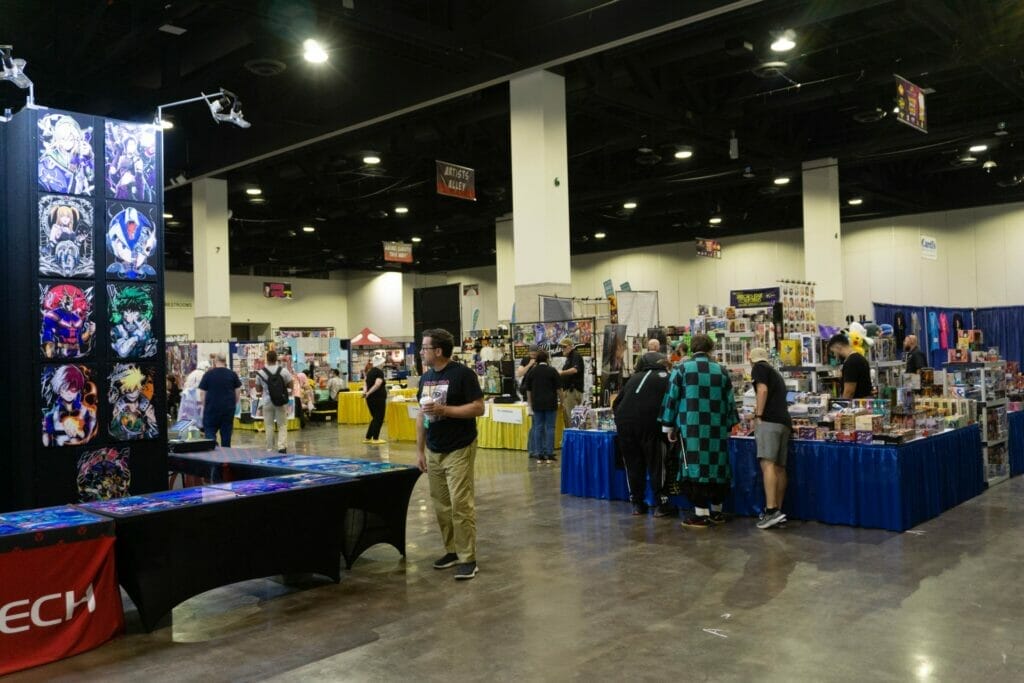 Photo from RI Anime Con 2023, which features several Exhibition Hall booths that are being patronized by attendees.