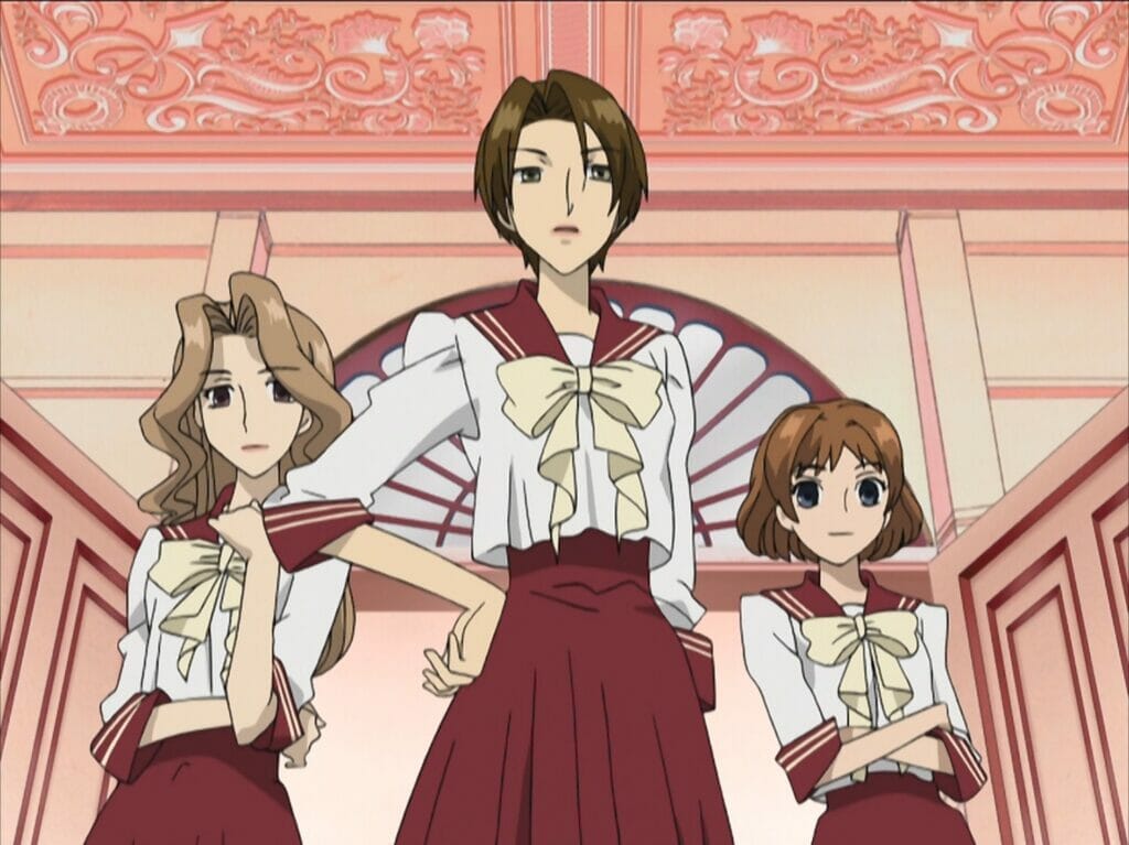 Screenshot from Ouran High School Host Club. Three women in sailor school uniforms pose dramatically under an ornate red ceiling.
