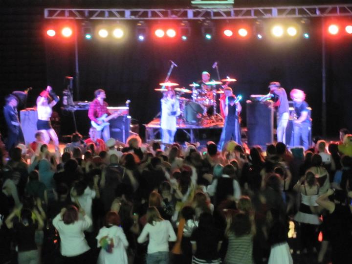 The LeetStreet Boys performing at a concert as hundreds gather around the stage.