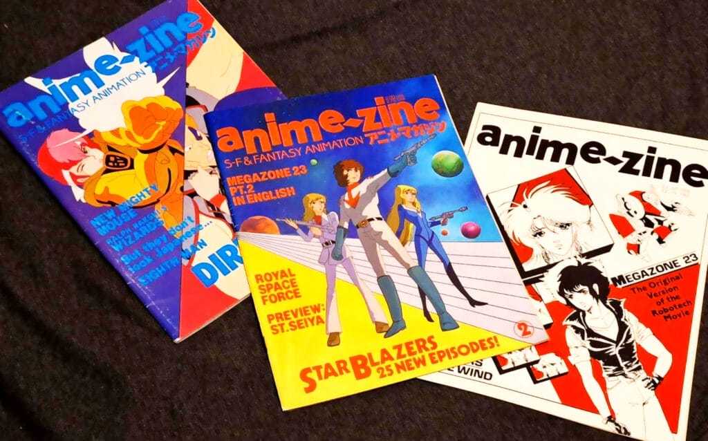 Photograph of the three issues of Anime-Zine, arranged in a row