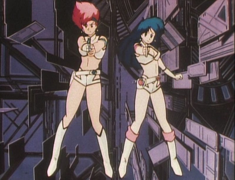 Screenshot from the Dirty Pair OVA that depicts Kei and Yuri pointing their guns at the camera
